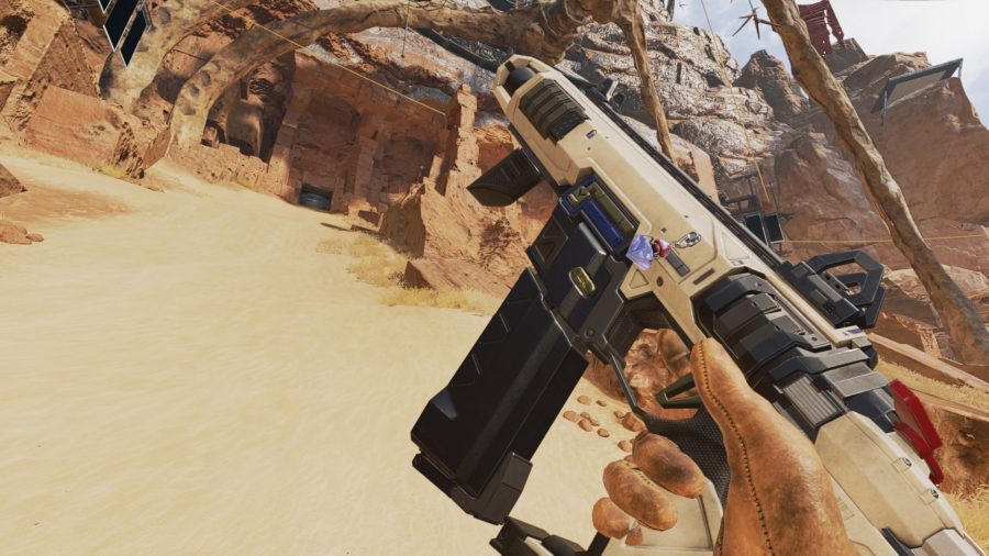 プレイヤーは砂漠の背景の前でなめらかな白いR-99SMGを検査します