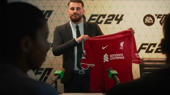 FC 24の選手経歴: 記者会見でリヴァプールの赤いシャツを掲げるスーツ姿の男性