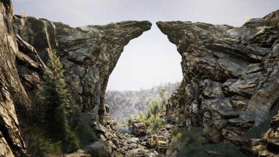 Expeditions のゲームプレイ: 遠くにある岩だらけのアーチ道を 2 台の大型トラックが走っています。